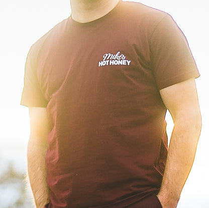 Person wearing Mike's Hot Honey short sleeve burgundy t-shirt